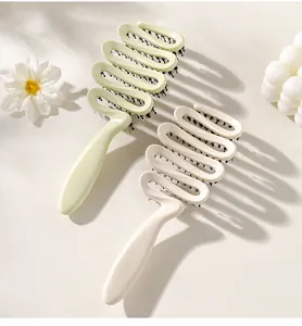 Dual S-shaped vented hairbrushes in mint and cream for detangling and styling hair