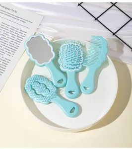 Close-up of cute light blue cloud-shaped hairbrush and mirror set for children and girls