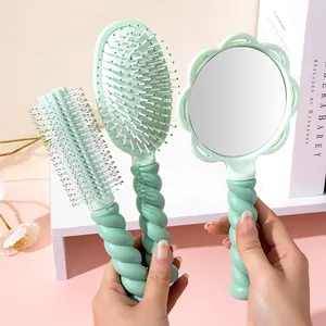 Mint green hair brush and mirror set with unique twist handle design for daily styling