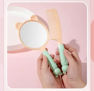 Detailed view of a cute mint green cat-themed handheld mirror and matching comb set.