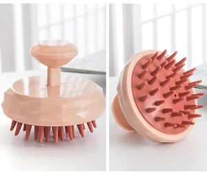 Detailed macro view showing soft silicone bristles and diamond-cut pink scalp massager.