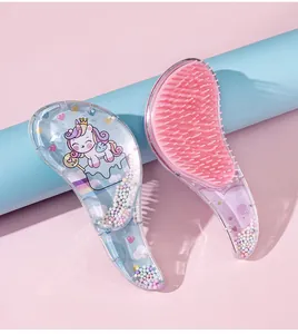 Detail shot of a pink unicorn cartoon detangling hairbrush with colorful beads inside.