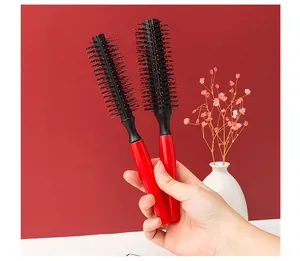 Detailed view of two professional red and black round hair brushes for hair styling