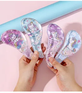Close-up of four colorful unicorn detangling hairbrushes with sparkling beads
