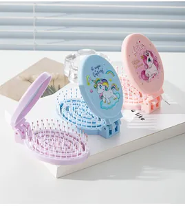 Detail of portable folding hairbrushes with mirrors featuring cute unicorn prints.