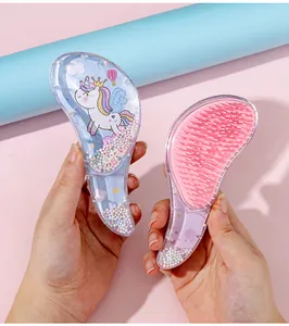 Detailed view of portable unicorn hairbrush with glitter beads and pink bristles