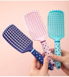 Detailed view of three colorful vented hair massage brushes with cute star pattern handles