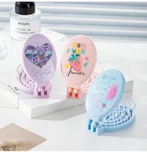 Detail view of portable cartoon folding hair combs with built-in mirrors in pastel colors