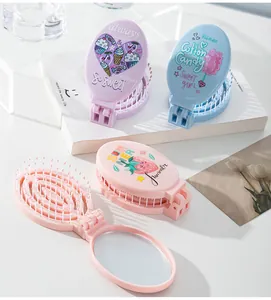 Detailed view of portable folding hairbrush with mirror in pastel purple, blue, and pink