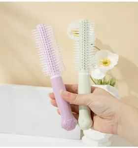Macro view of pastel pink and green hairbrushes with cute cat paw handles