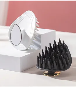Leaf-shaped scalp massage brush with soft silicone bristles in white and black