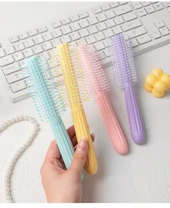 Detailed view of macaron color round roller hair brushes for voluminous hair styling