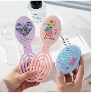 Set of three colorful portable folding hair combs with cute cartoon strawberry prints