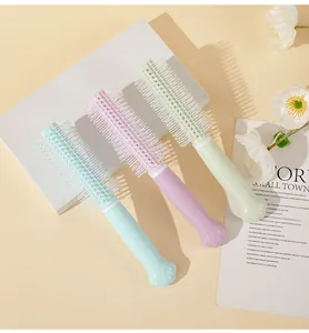 Detailed view of pastel colored rolling hairbrushes with cute cat paw shaped handles