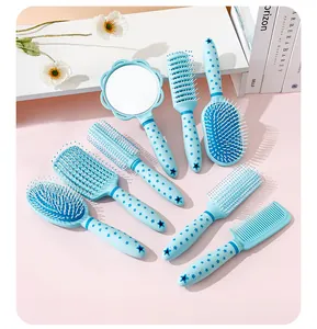Detail view of a professional blue star-patterned hairbrush set and hand mirror (81 chars)