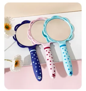 Detail of colorful handheld mirrors with star-patterned handles for girls and women.