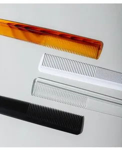 Detailed close-up view of plastic fine-tooth barber combs in various colors