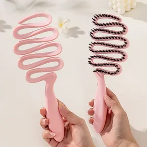 Pink ergonomic S-shaped boar bristle hairbrush for detangling and adding volume
