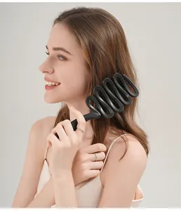 Detailed macro view showing the ergonomic black wavy hairbrush with a speckled finish.