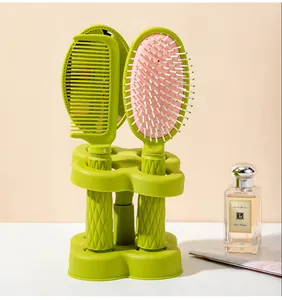 Green 4-piece hairbrush set with massage comb, mirror, and storage base holder