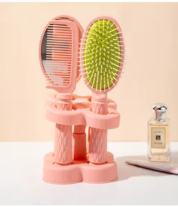 Detailed display of pink multifunctional hair comb set with stand and vanity mirror