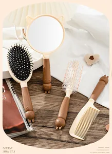 Detailed view of the cute chocolate brown cartoon cat hairbrush and mirror set