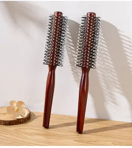 Detail view of reddish brown wooden round brushes with black and white bristles