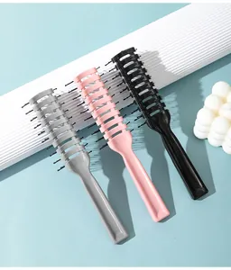 Detail shot of three colorful vent brushes for men's hair styling and scalp massage.