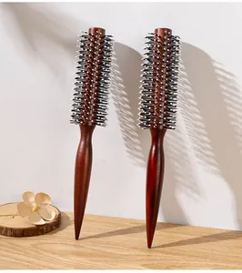 Detail view of professional reddish brown wooden round hair brushes for hair styling