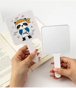 Detailed view of the cute cartoon panda print and HD glass surface of the handheld square mirror.