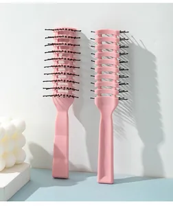 Close-up of pink vented hair brushes for scalp massage and volumizing styling