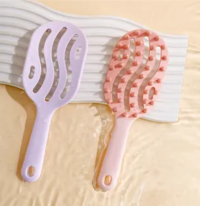 Detail view of hollow scalp massage brushes in purple and pink with water ripples