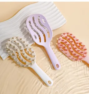 Detail view of hollowed-out massage hairbrushes in pastel colors with water ripples