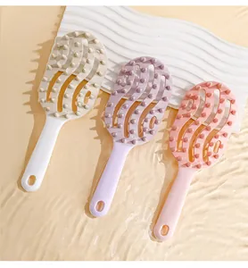 Top view of three colorful hollow hair massage brushes for wet and dry scalp cleaning