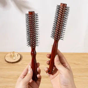 Pair of reddish-brown wooden round hair brushes for professional hair styling.