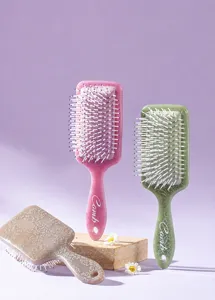 Close-up of printed paddle hairbrushes with vintage patterns and massage bristles