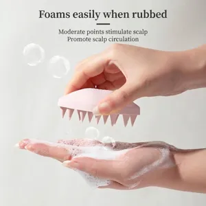 Shell-shaped silicone scalp massager brush for effective hair cleaning and relaxation.