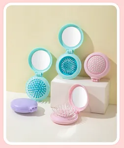Portable 2-in-1 foldable hairbrush with mirror in various pastel colors for travel.