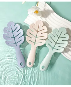 Set of three colorful leaf-shaped silicone shampoo brushes in a refreshing water scene