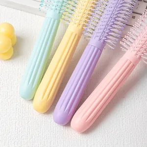 Macaron colored hair roller brush with anti-slip handle for volumizing styling.