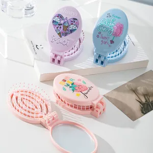 Portable folding hair brush with mirror featuring cute cartoon strawberry prints