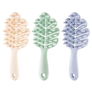 Set of three leaf-shaped silicone shampoo brushes in pastel colors with ergonomic handles