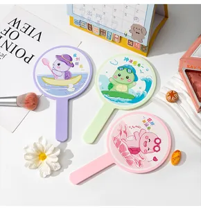 Detailed view of three pastel handheld mirrors featuring cute cartoon turtle prints