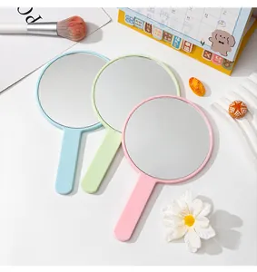 Set of three colorful pastel handheld mirrors with handles for makeup and travel portability