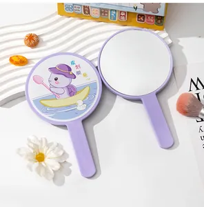 Close-up detail of the cute cartoon turtle print on a purple portable handheld makeup mirror
