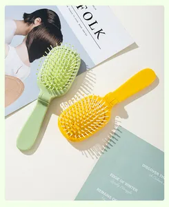 Portable folding air cushion hairbrush in vibrant green and yellow for daily hair care