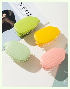 Close-up details of cactus-shaped folding hairbrushes in green, yellow and pink colors