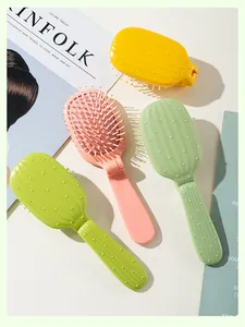 Detail view of colorful cactus-shaped folding hair brushes with massage cushions