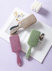 Detailed view of square paddle hairbrushes with elegant totem prints in multiple colors