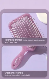 Macro detail of purple totem print paddle brush featuring white round-tip massage bristles